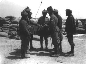 14th Sikhs of the 29th Indian Infantry Brigade examining a piece of shell from 'Asiatic Anne' that fell on their camp, Gallipoli, 1915