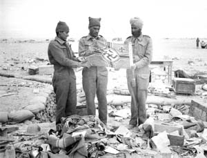 Indian soldiers holding a Nazi flag after Libyan Omar was taken by Indian troops