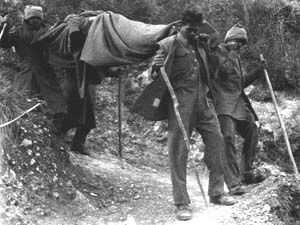 Indian stretcher bearers carry a badly wounded man at Cassino
